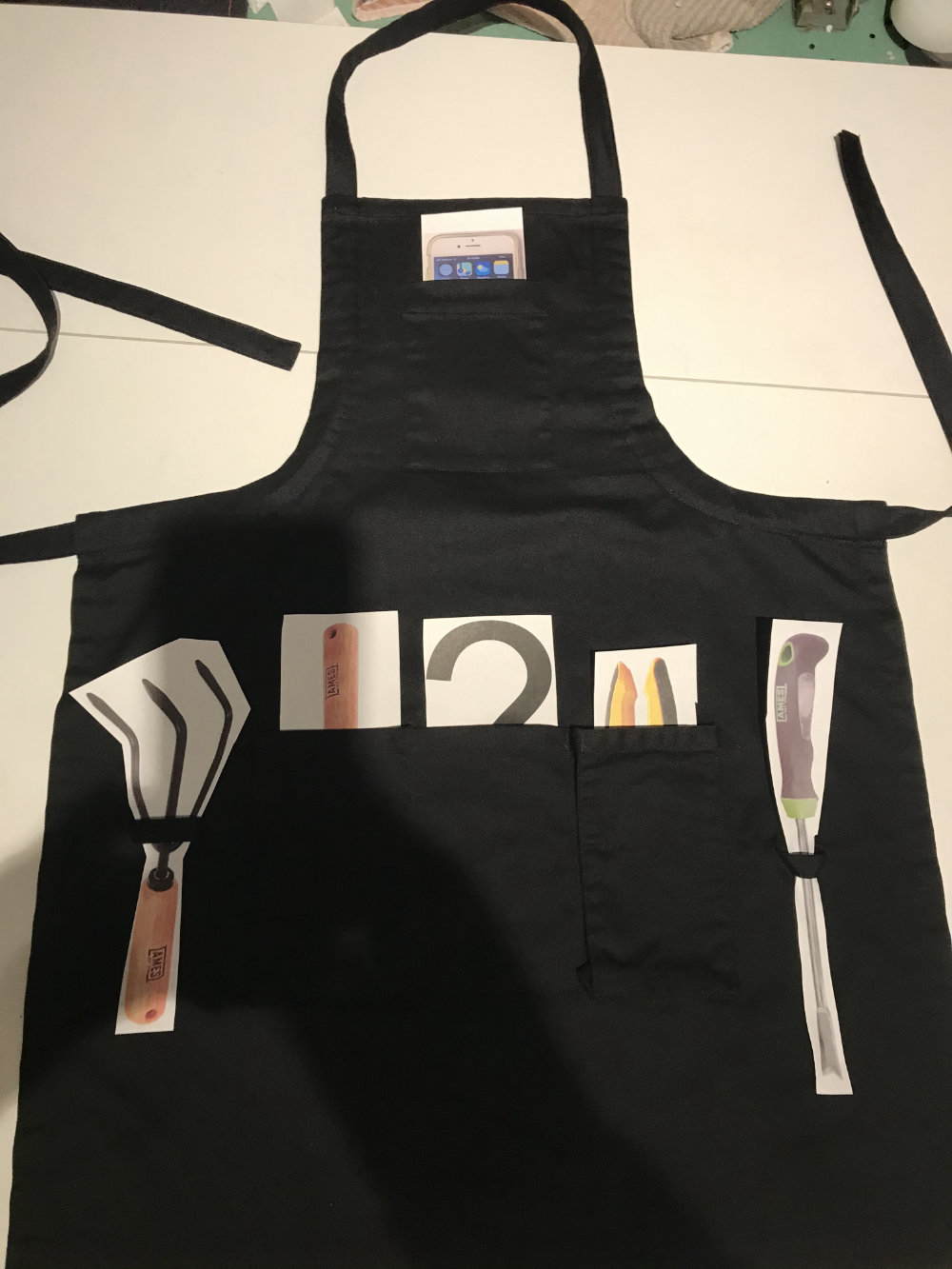 gardening apron with paper cutouts of tools