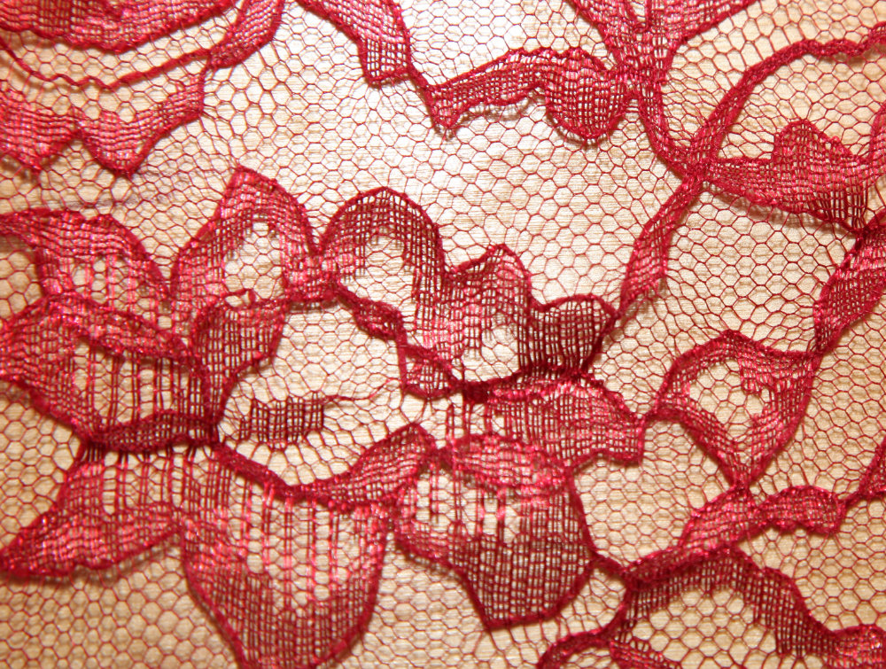 Lace red lace fabric that you can see the table underneath through. Transparency is one thing to consider when choosing fabric for your projects