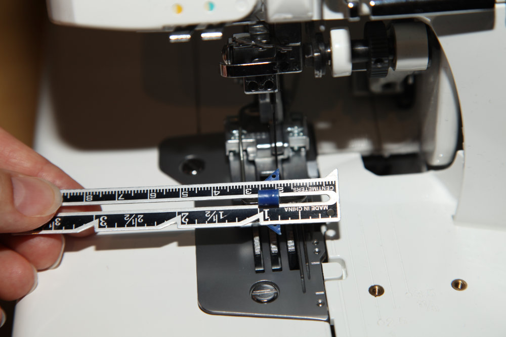 Using a seam guage to measure for seam allowance on sewing machine